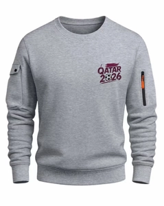 Detail of grey sweatshirt showing Qatar 2026 print and utility sleeve zipper pocket