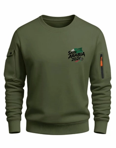 Detail of olive green sweatshirt showing sleeve pocket and Saudi Arabia 2026 graphic
