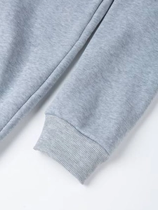 Close-up of gray hoodie ribbed cuff showing high-quality knitted fabric texture