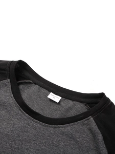 Detail of crew neck stitching and size label on the grey raglan sleeve t-shirt
