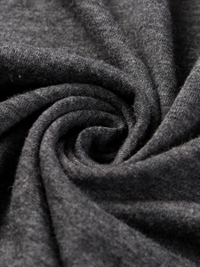 Macro shot of dark grey knit fabric texture showing premium cotton blend weave details