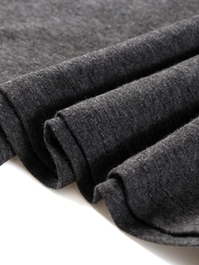 Detail of dark grey heather fabric texture and double-needle stitching on long sleeve tee