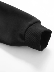 Close-up of black hoodie sleeve with ribbed cuff detail showing high-quality fabric texture