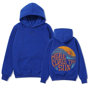 Detail of blue hoodie featuring Here Comes The Sun retro sunset graphic and kangaroo pocket