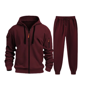 Detail view of burgundy men's tracksuit featuring a zip-up hoodie and textured knit joggers