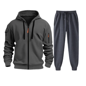 Detail of dark grey track suit with hood, zipper pocket and bright orange accents