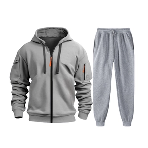 Detail of grey men's tracksuit showing zipper hoodie with orange accents and ribbed cuffs