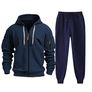 Detail of navy blue men's tracksuit featuring orange zipper pulls and drawstring hoodie