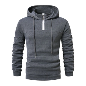Detail of grey men's hoodie with half-zipper, layered collar, and drawstring on white background