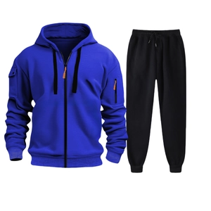 Detail view of royal blue zip-up hoodie and black joggers set with orange accents
