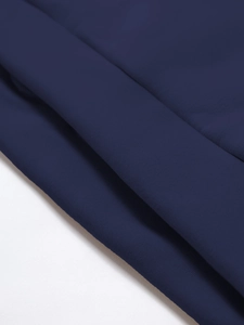 Macro detail of dark blue high-density knit fabric showing smooth matte texture and drape
