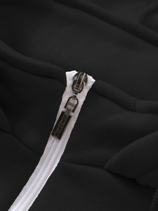 Macro shot of high-quality metallic zipper detail on black men's hooded sweatshirt