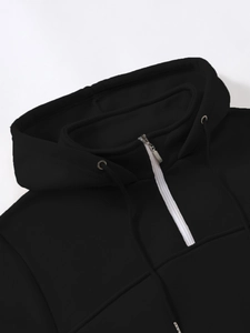 Close-up of black hoodie with contrasting white half-zip and high-quality fabric texture