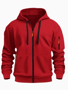 Detail view of red men's zip-up hoodie featuring multi-pocket design and orange accents