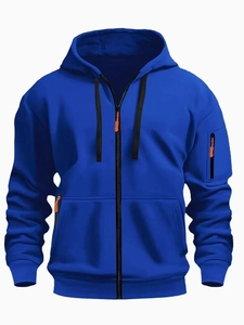 Detail of royal blue zip hoodie with orange zipper accents and sleeve pocket