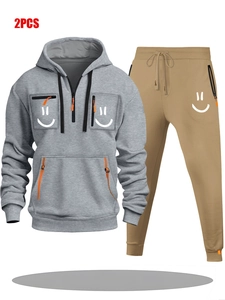 Detail of hoodie set featuring multiple orange zipper pockets and smile print designs