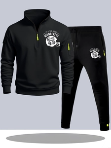 Detail of black tracksuit featuring a quarter-zip collar and helmet graphic print