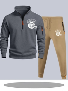 Detail of grey half-zip sweatshirt and khaki joggers with football theme festive print