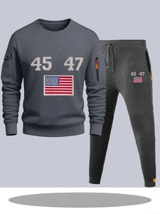 Detail of dark grey tracksuit showing American flag print and drawstring jogger texture