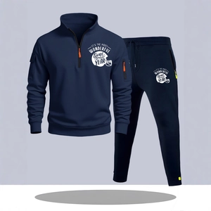 Men's navy tracksuit set with quarter-zip hoodie and joggers featuring graphic prints