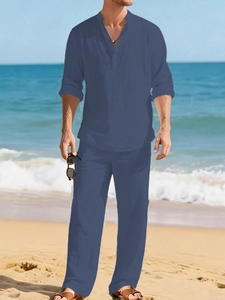 Detail of navy linen beach set featuring a long sleeve henley shirt and matching trousers