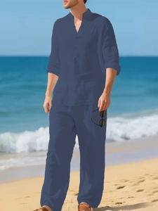 Close-up of deep blue linen blend fabric on a casual men's long sleeve henley shirt and pants