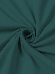 Close-up of forest green heavy knit hoodie fabric showing soft texture and thickness