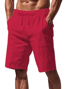 Detailed view of red cotton linen shorts with elastic waistband and drawstring closure