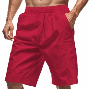 Detail of red cotton linen shorts featuring an elastic waistband with adjustable drawstring