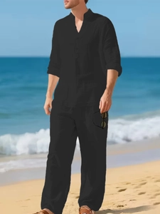 Close-up of lightweight black linen blend shirt and loose trousers for men's beach vacation