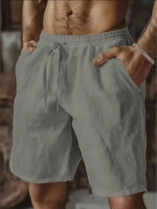 Detail of men's grey linen shorts featuring an adjustable drawstring and elastic waistband