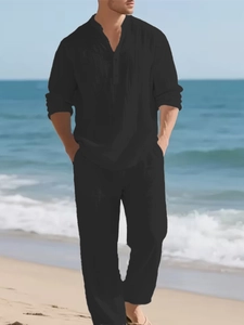 Black linen men's casual set with long sleeve Henley shirt and straight pants on beach