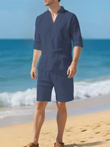 Detailed texture of navy linen shirt and shorts set on a sunny summer beach