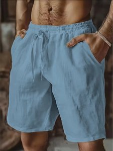 Detail of light blue linen shorts featuring elastic drawstring waistband and side pockets