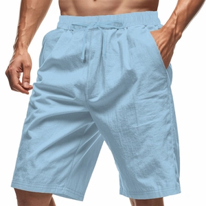 Detail of light blue linen shorts featuring an elastic drawstring waist and side pockets