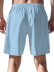 Rear view of men's light blue cotton linen shorts featuring an elastic drawstring waist