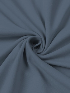 Detailed close-up of dark blue-grey knitted fabric with soft fine texture and drape