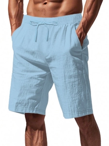 Detail of light blue cotton linen shorts featuring drawstring waist and side pockets