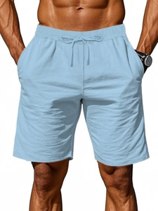 Detail view of men's cotton linen shorts featuring elastic drawstring waist and side pockets
