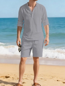 Close-up of linen fabric texture on grey Henley shirt and drawstring shorts at the beach