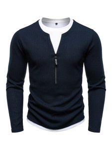 Detail of navy knit sweater featuring 1/4 zipper collar and layered faux two-piece design