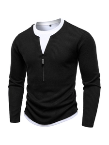 Detail of black ribbed knit shirt with zipper neck and white layered faux collar detail