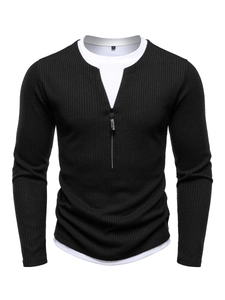 Detail of waffle texture fabric and zipper collar on men's black knit sweater