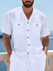 Detail of white linen shirt for men featuring classic cuban collar and dual chest pockets