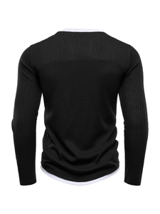 Detail of men's black knit sweater back view with white faux layer trim at the bottom hem