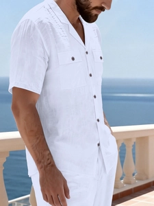 Detail of white linen beach shirt featuring notch lapel and wooden buttons for men