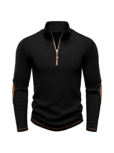Detail of men's black ribbed knit sweater with 1/4 zip and brown leather trim accents