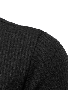 Close-up of shoulder seam and ribbed knit texture on a black long-sleeve sweater