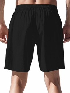 Rear view of men's black athletic shorts featuring an elastic waistband and breathable fabric