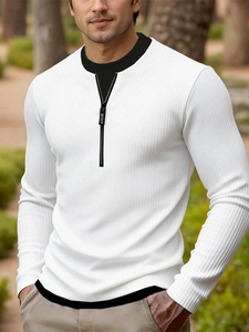 Detail of male knit sweater featuring white ribbed fabric and a black contrast collar with zipper